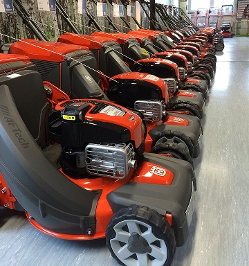 Small engine lawnmowers in a shop.